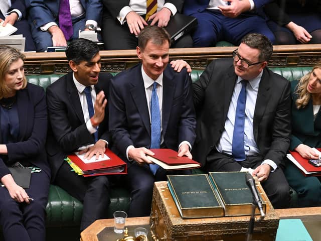 The Chancellor is congratulated after his Autumn Statement.