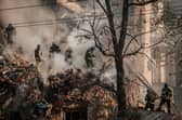 Ukrainian firefighters work on a destroyed building after several drones hit Kyiv on Monday (Picture: Yasuyoshi Chiba/AFP via Getty Images)