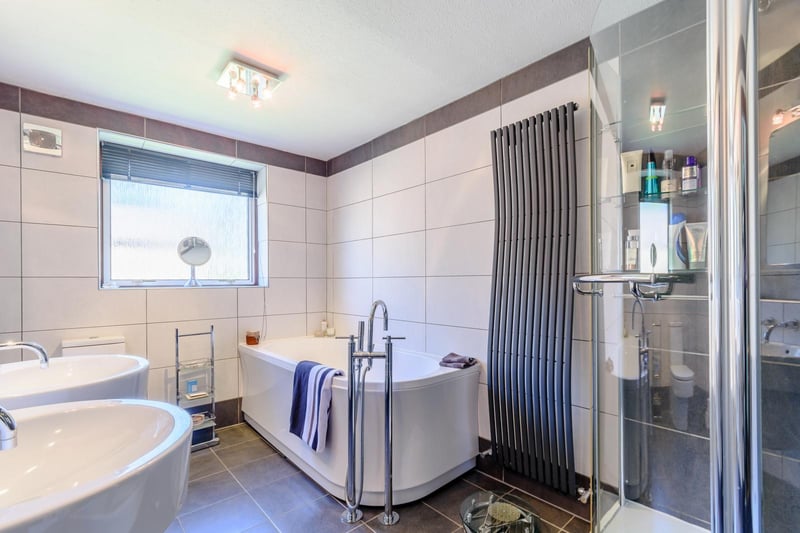 The family bathroom has a large corner shower unit, a panelled bath, a low flush W.C and floating twin wash hand basins. Elsewhere in the house there is a second bathroom presented with a three piece suite finished in white with a shower over the bath.