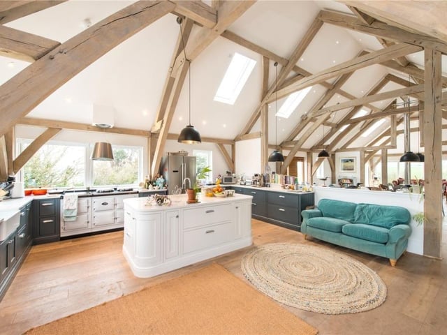 The kitchen has lovely sea views and features a five oven AGA, range of units with stone worksurfaces, central island with prepping sink, separate double Belfast sink, and integrated dishwasher.