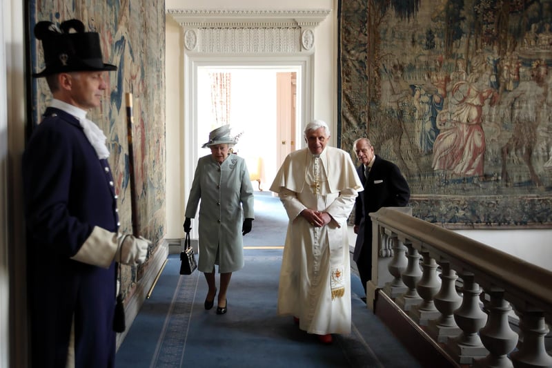 Queen Elizabeth II and Prince Philip, Duke of Edinburgh walk with Pope Benedict XVI to the Morning Drawing Room in the Palace of Holyroodhouse.