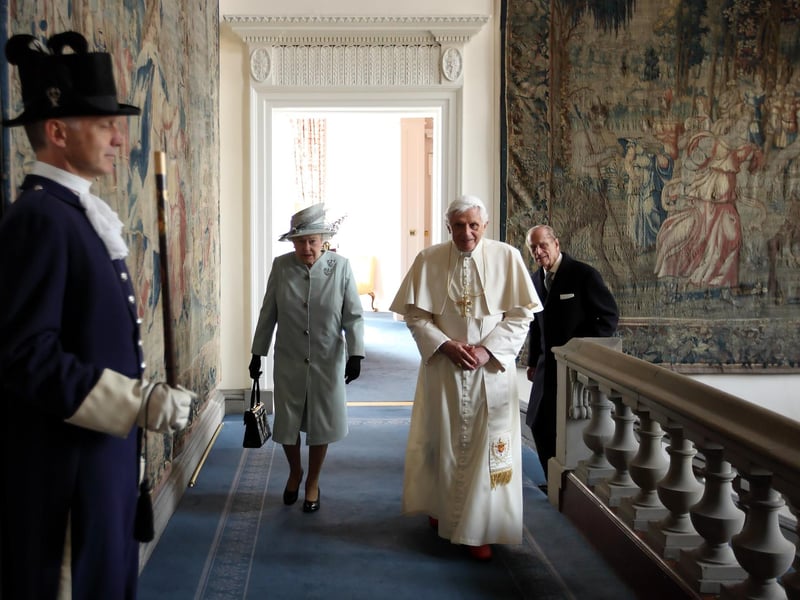 Queen Elizabeth II and Prince Philip, Duke of Edinburgh walk with Pope Benedict XVI to the Morning Drawing Room in the Palace of Holyroodhouse.