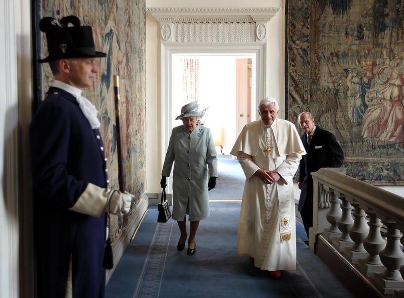 Queen Elizabeth II and Prince Philip, Duke of Edinburgh walk with Pope Benedict XVI to the Morning Drawing Room in the Palace of Holyroodhouse.