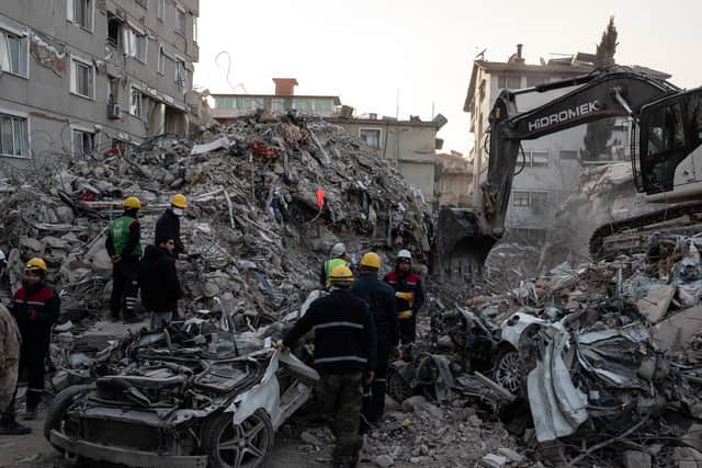 An excavator digs at the site of collapsed building to remove the debris on February 16, 2023 in Hatay, Turkey. (Photo by Burak Kara/Getty Images)