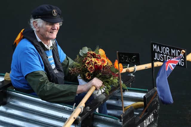 Michael Stanley, with some flowers for his wife Sally, ahead of their golden wedding anniversary tomorrow, rows along the Chichester canal, West Sussex, in his home-made boat Tintanic as he nears 70 miles completed in his rowing challenge.