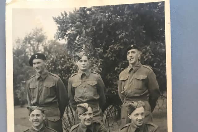 George with other British soldiers in uniform given to them by the Red Cross. Back row, left to right: Tyson, Ted Rose, Willy Wilson. Front row: Johnny Jones, George Simpson, McGregor.