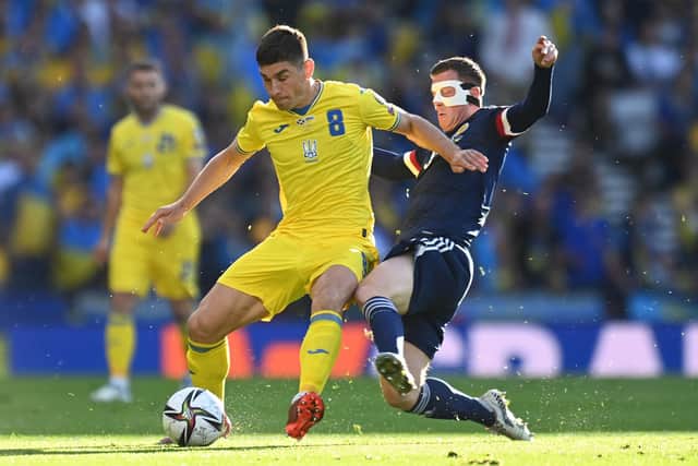 Ukraine's Ruslan Malinovsky (left) and Scotland's Callum McGregor battle for the ball at Hampden.