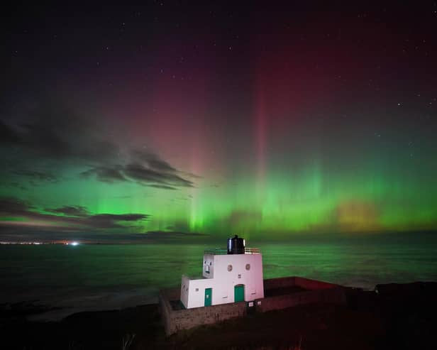 The aurora borealis, also known as the northern lights, appears over Bamburgh Lighthouse, in Northumberland on the north east coast of England. Picture: Owen Humphreys/PA Wire