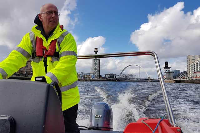 Glasgow Humane Society vice-chairman Gordon Goldie at the helm of the new boat