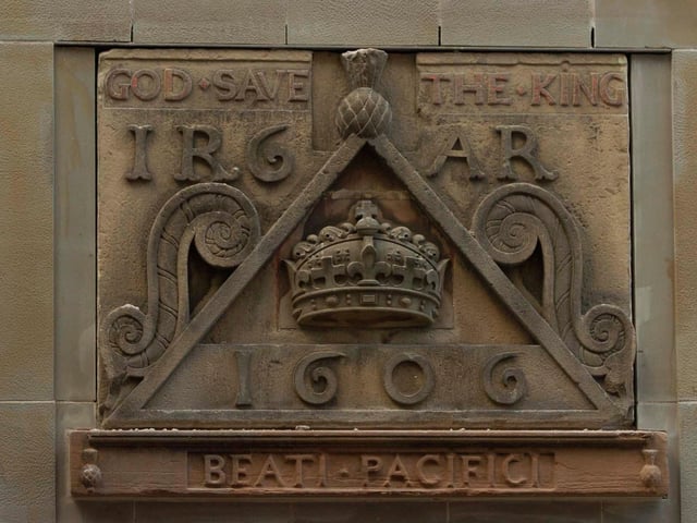 This 17th century stone inscription can be found on the facade of which 21st century development?