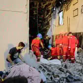 Firefighters check the damage in an event hall in Qaraqosh, also known as Hamdaniyah, after a fire broke out during a wedding, killing at least 100 people and injuring more than 150.