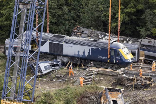 A carriage being lifted by a crane from the site of the Stonehaven rail crash as work continues at the scene in Aberdeenshire, following the derailment of the ScotRail train that cost the lives of three people. Picture: Derek Ironside/Newsline Medial/PA Wire