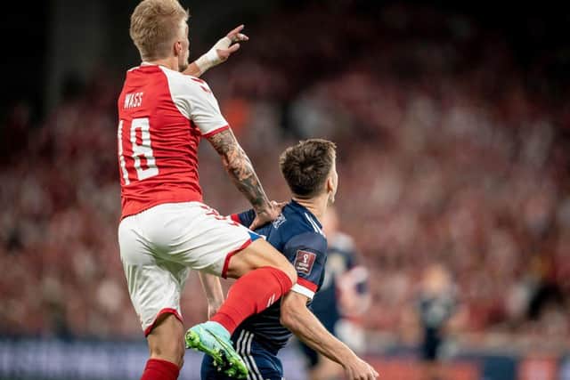Denmark's Daniel Wass (Up) vies for the ball during the 2022 FIFA World Cup qualifier group F football match between Denmark and Scotland at Parken Stadium in Copenhagen on September 1, 2021. (Photo by MADS CLAUS RASMUSSEN/Ritzau Scanpix/AFP via Getty Images)