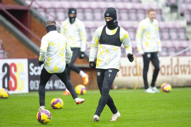 Stephen Kingsley wraps up warmly during Hearts' final training session ahead of the match against Kilmarnock. Photo by Ewan Bootman / SNS Group