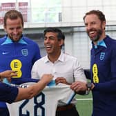 Rishi Sunak receives an England shirt alongside striker Harry Kane and England manager Gareth Southgate (Picture: Darren Staples/WPA pool/Getty Images)