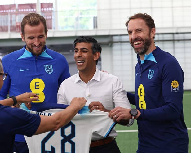 Rishi Sunak receives an England shirt alongside striker Harry Kane and England manager Gareth Southgate (Picture: Darren Staples/WPA pool/Getty Images)