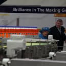 Queen Elizabeth II with Chief Executive Roger White in the bottling plant during a visit to AG Barr's factory in Cumbernauld.
