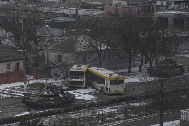 Russian army tanks move down a street on the outskirts of Mariupol on March 11 (Picture: Evgeniy Maloletka/AP)