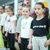 Refugees living in temporary accommodation, like these girls who are housed on a cruise ship in Edinburgh, have started moving into refurbished social housing in Wishaw.