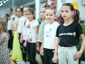 Refugees living in temporary accommodation, like these girls who are housed on a cruise ship in Edinburgh, have started moving into refurbished social housing in Wishaw.