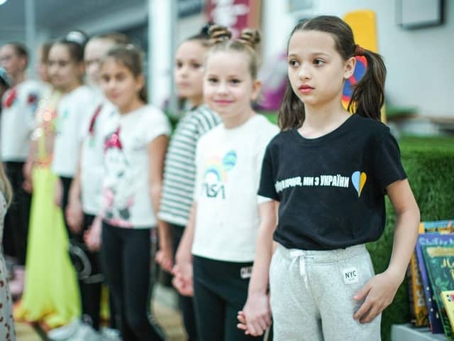 Refugees living in temporary accommodation, like these girls who are housed on a cruise ship in Edinburgh, have started moving into refurbished social housing in Wishaw.