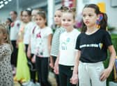 Refugees living in temporary accommodation, like these girls who are housed on a cruise ship in Edinburgh, have started moving into refurbished social housing in Wishaw.