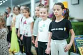 Refugees living in temporary accommodation, like these girls who are housed on a cruise ship in Edinburgh, have started moving into refurbished social housing in Wishaw.