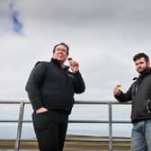 Allan Logan, Bruichladdich Distillery production director (left), samples a glass of The Regeneration Project with farmer Andrew Jones. Picture: Bruichladdich Distillery
