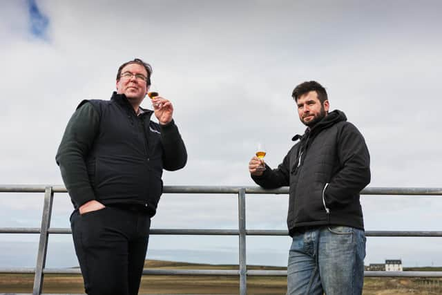 Allan Logan, Bruichladdich Distillery production director (left), samples a glass of The Regeneration Project with farmer Andrew Jones. Picture: Bruichladdich Distillery