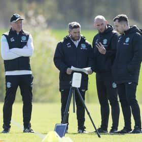 Hibs manager Lee Johnson, centre, talks to his coaches ahead of facing St Johnstone this weekend.
