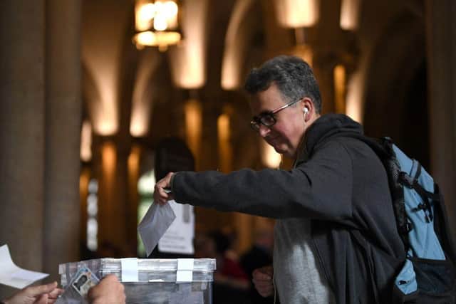 A voter casts his ballot at a polling station in the University of Barcelona, at the weekend, during Catalonia's regional election.