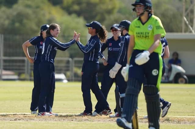Bowler Katherine Fraser is congratulated by her Scotland team-mates