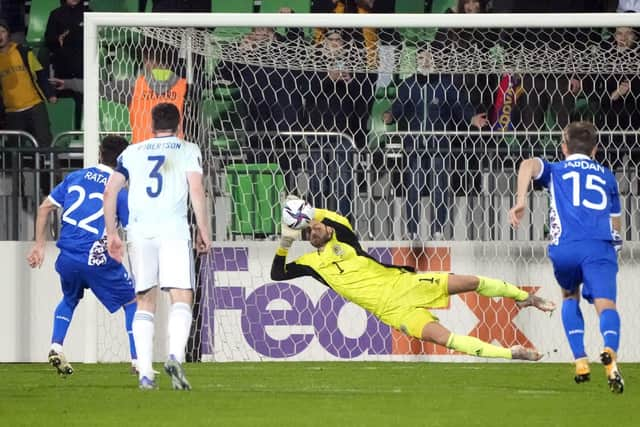 Craig Gordon saves a penalty to help Scotland avoid a nervy finish. (AP Photo/Sergei Grits)