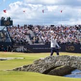 Tiger Woods waves to the crowd as he crosses over the Swilken bridge at the end of his second round at the Old Course, St Andrews, Scotland.
