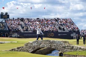 Tiger Woods waves to the crowd as he crosses over the Swilken bridge at the end of his second round at the Old Course, St Andrews, Scotland.
