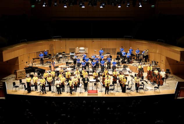 Sir Andrew Davis and the RSNO dressed in the blue and yellow of Ukraine