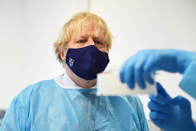 Prime Minister Boris Johnson is shown the Lighthouse Laboratory, used for processing polymerase chain reaction (PCR) samples for coronavirus, during a visit to the Queen Elizabeth University Hospital campus in Glasgow on his one day visit to Scotland.