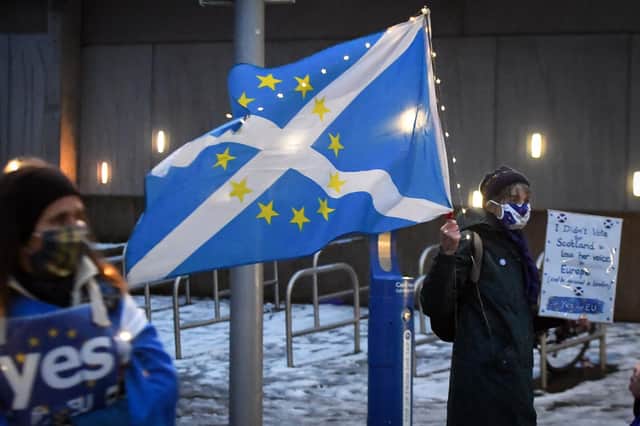 Anti-Brexit, pro-Scottish independence activists hold a small protest against the UK's exit from the European Union outside the Scottish Parliament on December 31, hours before the end of the transition period (Picture: Andy Buchanan/AFP via Getty Images)