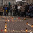 People gather in Kyiv next to candles that are put in order to depict the word 'Children' during a memorial event on the anniversary of the Mariupol Theater Airstrike. Picture: Roman Pilipey/Getty Images