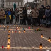People gather in Kyiv next to candles that are put in order to depict the word 'Children' during a memorial event on the anniversary of the Mariupol Theater Airstrike. Picture: Roman Pilipey/Getty Images