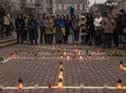 People gather in Kyiv next to candles that are put in order to depict the word 'Children' during a memorial event on the anniversary of the Mariupol Theater Airstrike. Picture: Roman Pilipey/Getty Images