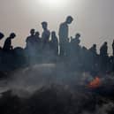 Palestinians gather at the site of an Israeli strike on a camp for internally displaced people in Rafah earlier this week (Picture: Eyad Baba/AFP via Getty Images)