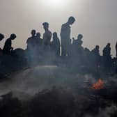 Palestinians gather at the site of an Israeli strike on a camp for internally displaced people in Rafah earlier this week (Picture: Eyad Baba/AFP via Getty Images)