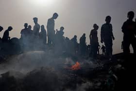 Palestinians gather at the site of an Israeli strike on a camp for internally displaced people in Rafah earlier this week (Picture: Eyad Baba/AFP via Getty Images)