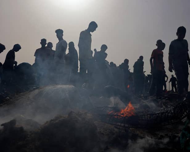 Palestinians gather at the site of an Israeli strike on a camp for internally displaced people in Rafah earlier this week (Picture: Eyad Baba/AFP via Getty Images)