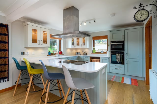 Interior: Its entrance hall features a welcoming stove and leads to an open-plan kitchen and dining room. The bay-windowed living room has doors opening to a terrace. Four bedrooms are spread over two floors.