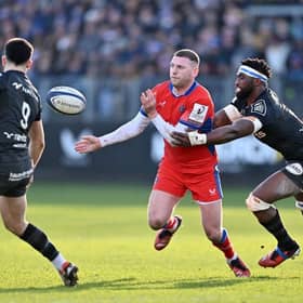 Finn Russell of Bath offloads under pressure from Siya Kolisi of Racing 92 during the Investec Champions Cup match at Recreation Ground. (Photo by Dan Mullan/Getty Images)