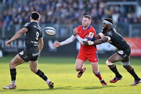 Finn Russell of Bath offloads under pressure from Siya Kolisi of Racing 92 during the Investec Champions Cup match at Recreation Ground. (Photo by Dan Mullan/Getty Images)
