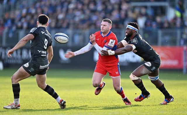 Finn Russell of Bath offloads under pressure from Siya Kolisi of Racing 92 during the Investec Champions Cup match at Recreation Ground. (Photo by Dan Mullan/Getty Images)