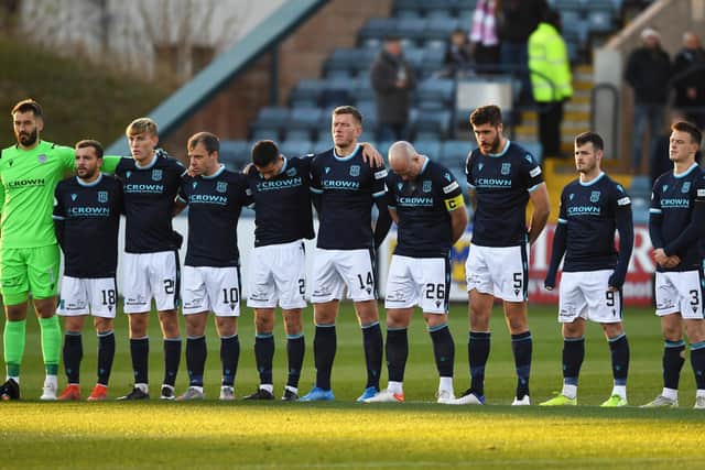 Dundee's player honour Cowie with a minute's silence.